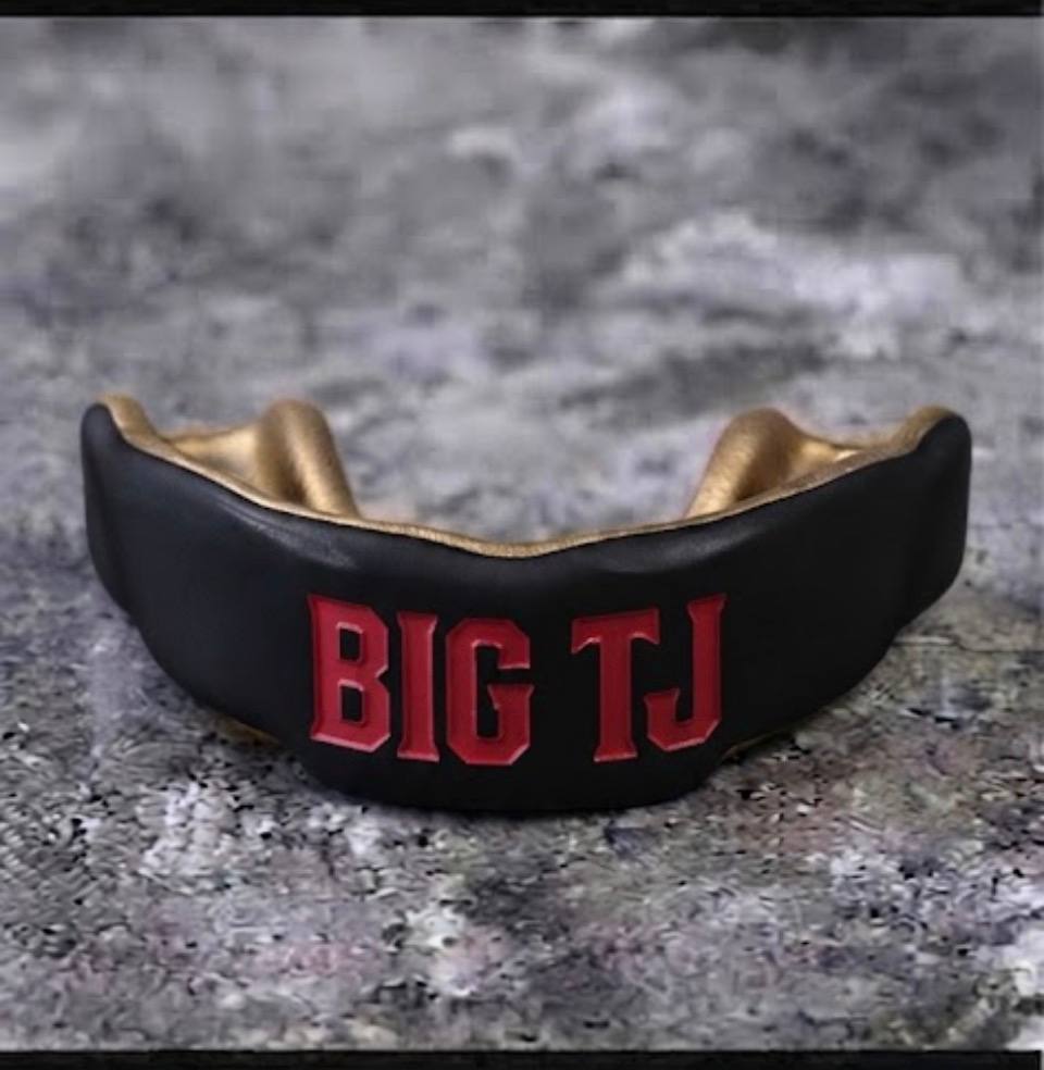 Custom black and gold mouthguard with BIG TJ lettering