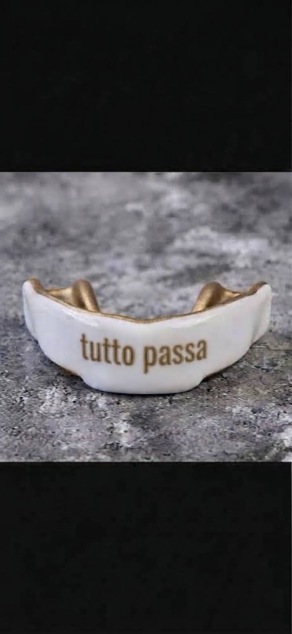 Custom white and gold mouthguard with tutto passa lettering