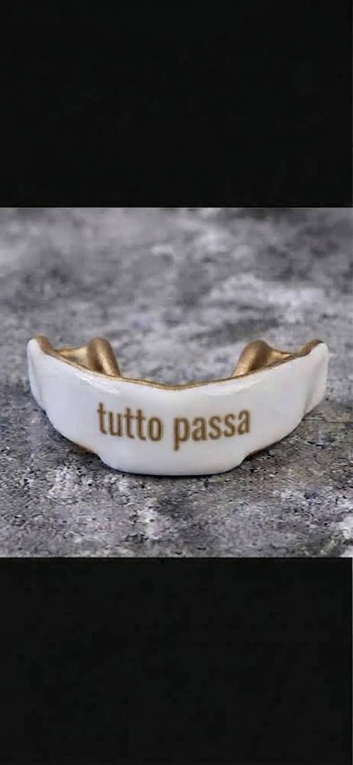 Custom white and gold mouthguard with tutto passa lettering
